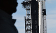 A SpaceX Falcon 9 rocket carrying the unmanned Crew Dragon capsule sits ready for launch o...