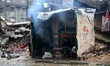 Palestinians set fire inside a tent in front of their home district Shijia during the deva...