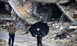  Child walking umbrella inside a devastating neighborhood into the neighborhood during rai...