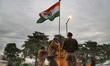 Security forces stand Guard at a Checkpoint with Indian Flag in the backdrop in New Delhi,...