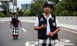 Balinese traditional guards, or pecalang, patrol a highway during the observation of Nyepi...