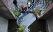 Officers prepare to catch fish at the abandoned shopping mall 'New World' in Bangkok, Thai...