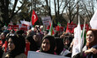 Women hold placards during a rally against the imprisonment of women and children in Syria...