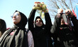 Women show their symbolically-handcuffed hands during a rally against the imprisonment of...