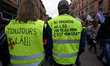 A Yellow Vest couple have written on their back 'Toulouse, still there!!' and 'No grenade,...