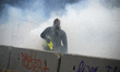 A Yellow Vest protester amid clouds of tear gas. For the Act 17 several thousands of prote...