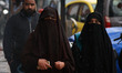 Kashmiri women walk as it rains in Srinagar,Kashmir on March 13, 2019. 