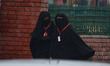 Kashmiri women walk as it rains in Srinagar,Kashmir on March 13, 2019. 