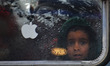 A Kashmiri boy looks from the passenger vehicle as it rains in Srinagar,Kashmir on March 1...