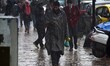 A Kashmiri man looks at his cellphone as it rains in Srinagar,Kashmir on March 13, 2019. 