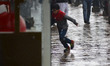 A Kashmiri boy runs as it rains in Srinagar,Kashmir on March 13, 2019. 