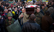 People carrying the coffin of a body of a dead anti-government demonstrator killed in yest...