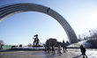 Students walk past the People's Friendship Arch in Kyiv, Ukraine on March 28, 2019. On Sun...