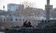 On 22 March, a couple holding hands sat on the castle walls of the historic Sur district o...