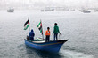 Hunters riding fishing boats inside the port of Gaza