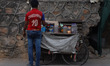 A vendor wearing Indian fast bowler Zaheer Khan's Jersey waits for the customers near his...