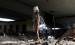 A Homeless kid takes bath near a railway station in Okhla New Delhi, India, on 29 March 20...