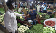 People buy vegetables from a evening market in Gurugram, Haryana, on 30 March 2019.
 