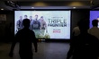 People walk infront of the Triple Frontier Netflix Series hoarding In New Delhi, India, on...