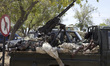 Somali National Army soldiers sleeping on their technical carrying a 14 mm gun parked next...