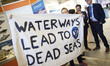 Extinction Rebellion eco activists holds a banner during interruption of Water Expo confer...