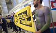 Extinction Rebellion eco activists holds a banner during interruption of Water Expo confer...