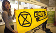 Extinction Rebellion eco activists holds a banner during interruption of Water Expo confer...