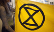Extinction Rebellion eco activists holds a banner during interruption of Water Expo confer...