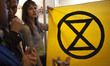 Extinction Rebellion eco activists holds a banner during interruption of Water Expo confer...
