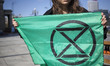 Extinction Rebellion flag holding by eco activists during disrupt of Water Expo conference...