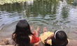 Children play in the water at a newly renovated community pond in Thrikkannapuram, Kerala,...