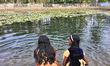 Children play in the water at a newly renovated community pond in Thrikkannapuram, Kerala,...