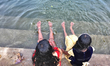 Children play in the water at a newly renovated community pond in Thrikkannapuram, Kerala,...