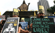 Participants of the Black Tuesday demonstration carry posters against the Cybercrime Act o...