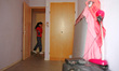 23 year-old Veronica Diaz Gestures as she passes next to an empty room as she waits for th...