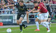 Macclesfield Town's Harry Smith is challenged by Northampton Town's Scott Pollock during t...