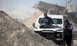 Momen Faiz, 31, a Palestinian NurPhoto photographer, takes photos from the top of a vehicl...