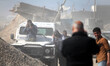 Momen Faiz, 31, a Palestinian NurPhoto photographer, takes photos from the top of a vehicl...