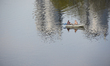 People are seen floating in a wooden boat on the Dnipro river in Kyiv, Ukraine on April 20...