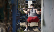 A man is seen exercising at the Kachalka outdoor scrapyard gym in Kyiv, Ukraine on April 2...