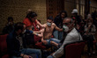 A man suffering from the burning effects of tear gas is treated inside the Divan Hotel beh...