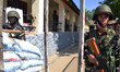  Indian policemen stands alert inside the compound of a polling station amid shutdown duri...
