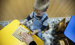 Orphan boy plays with developing toy, Orphanage 'Zhytomyr regional children home', Ukraine...