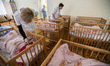 Orphan newborn lays in the cradle, Orphanage 'Zhytomyr regional children home', Ukraine. 2...