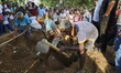 Gravediggers putting the soil over the casket of deceased,Loganathan Ramesh, 31 yrs old....