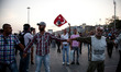 Protesters form a human chain opposite police in Taskim Square moments before operations b...