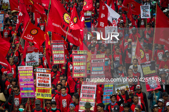 Indonesian workers take part in a May Day rally in Jakarta on May 1, 2019.  Thousands of Indonesian workers are urging the government to rai...