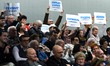 Voters from the Russian speaking community hold placards in support of Israeli Prime Minis...