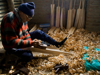 HALMULLAH, INDIAN ADMINISTERED KASHMIR, INDIA - FEBRUARY 11: A worker shapes an unfinished cricket bats in a cricket bats factory on Februar...
