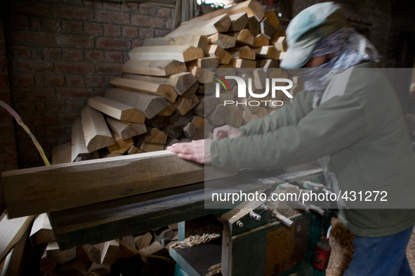 HALMULLAH, INDIAN ADMINISTERED KASHMIR, INDIA - FEBRUARY 11: A workers shape willow cleft used in making cricket bats in a cricket bat facto...